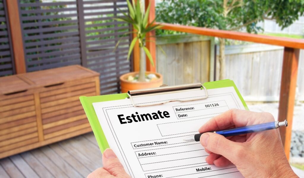 Hand writing an estimate on a clipboard for Home Building Renovation