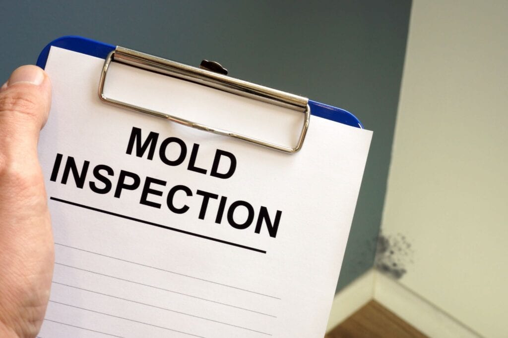 A clipboard with mold inspection written on it.