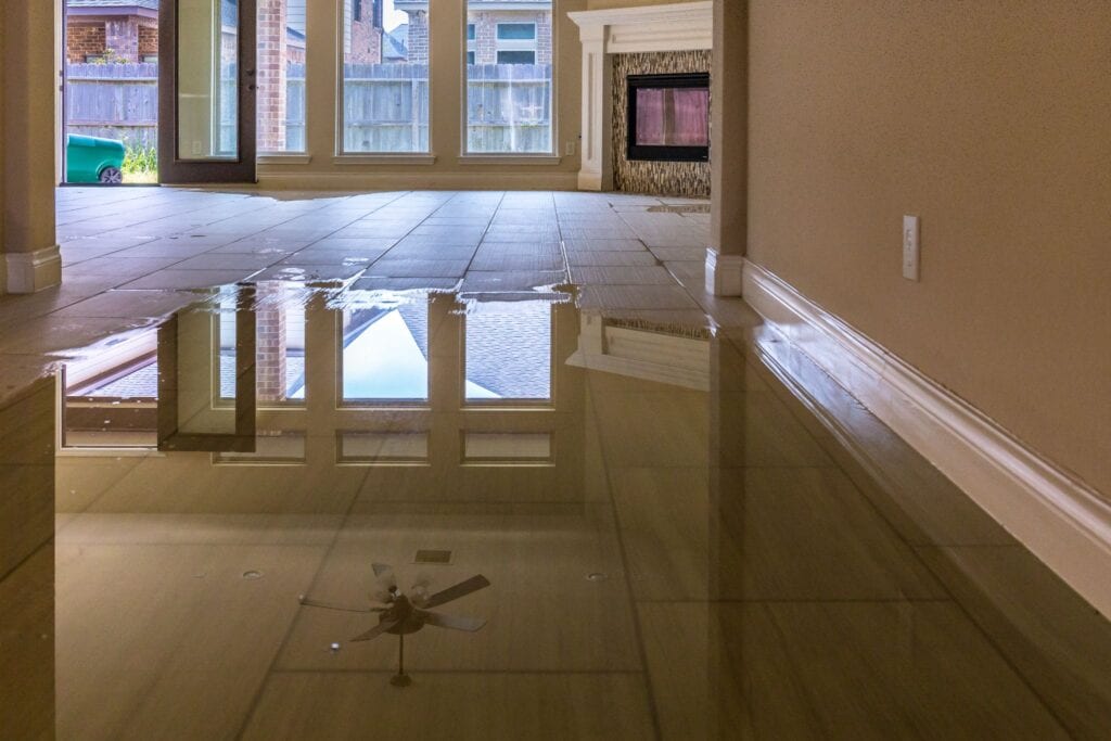 A flooded room with water on the floor.