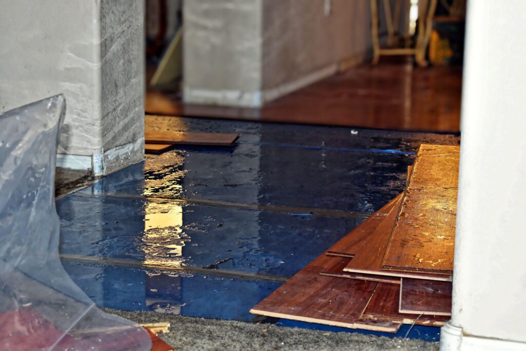 A flooded floor with wood flooring in the middle of it.