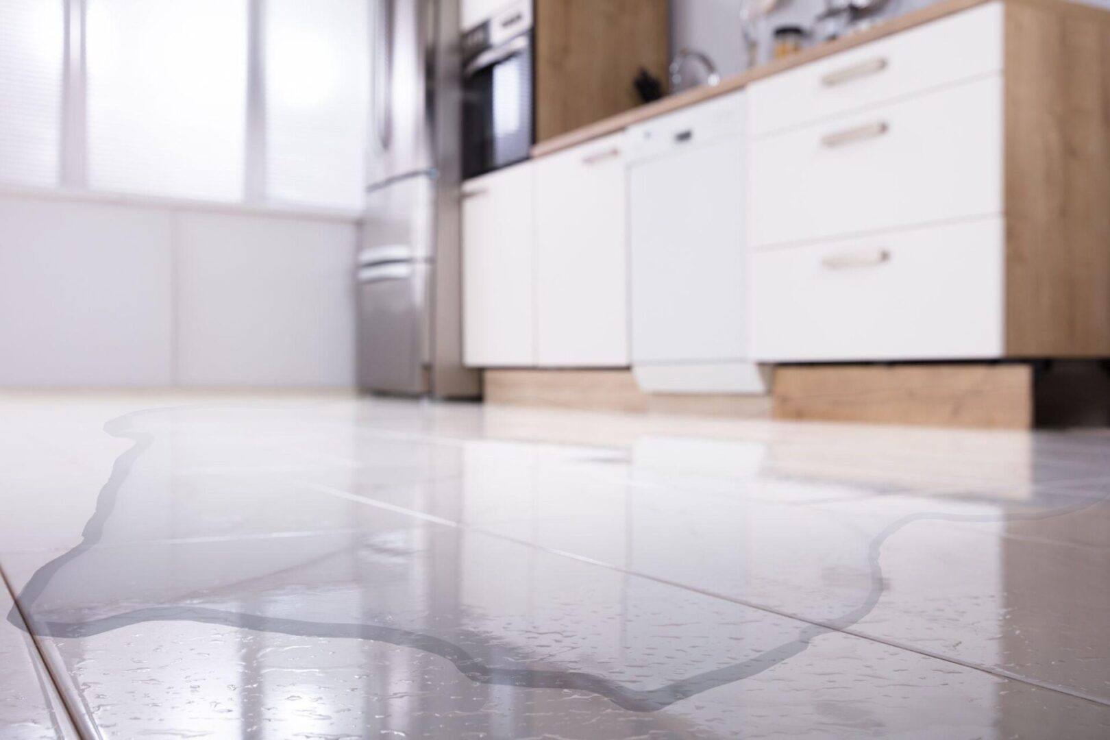 A kitchen with white tile floors and a counter.